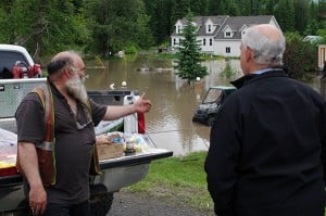 Kootenay East MLA Bill Bennett speaks with Hosmer residents impacted by the flooding Elk River June 21. Ian Cobb/e-KNOW