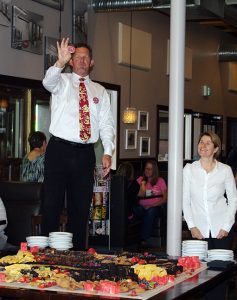 David D Hull explains the big prizes available with the purchase of a Sam Steele Days pin, while Heid-Out owner Heidi ???? looks on.