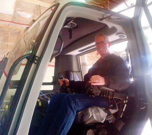 Mayor Don McCormick gets a feel for the Snowcat cockpit.