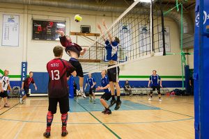 Gavin Barber, jumping, of the Baker Boys Senior Volleyball team.